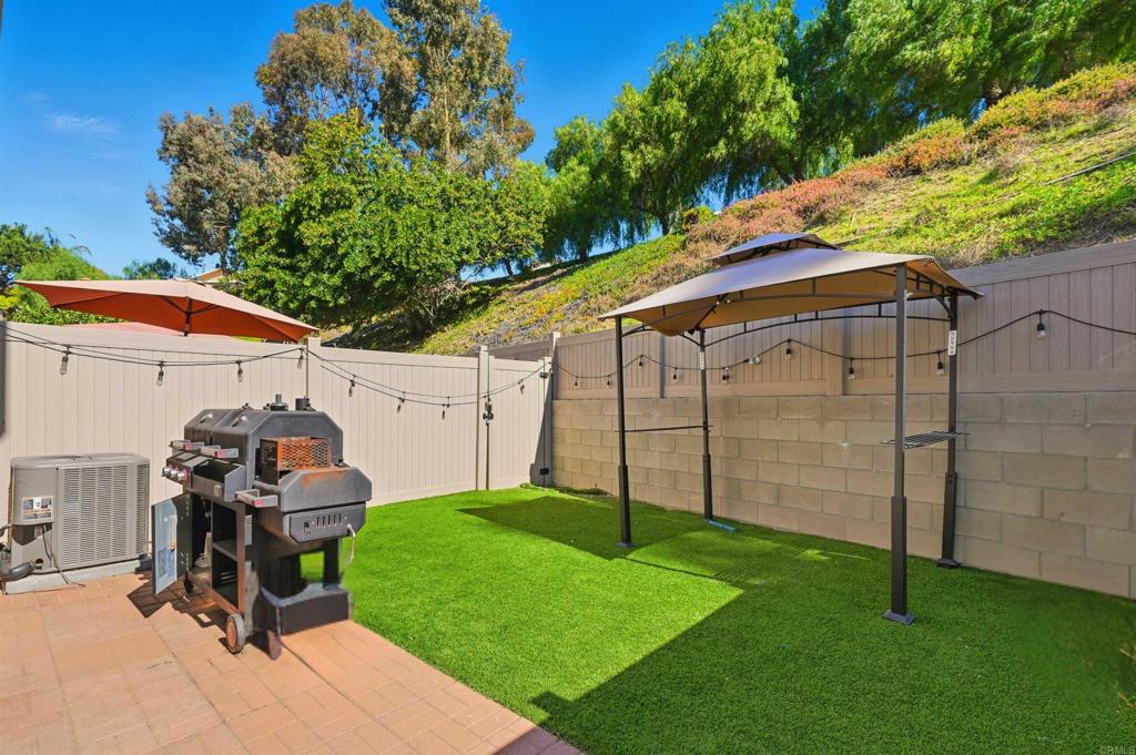8765 Spring Canyon Drive Spring Valley, CA 91977 - Photo 19 of 37 a view of a chair and table in backyard of the house