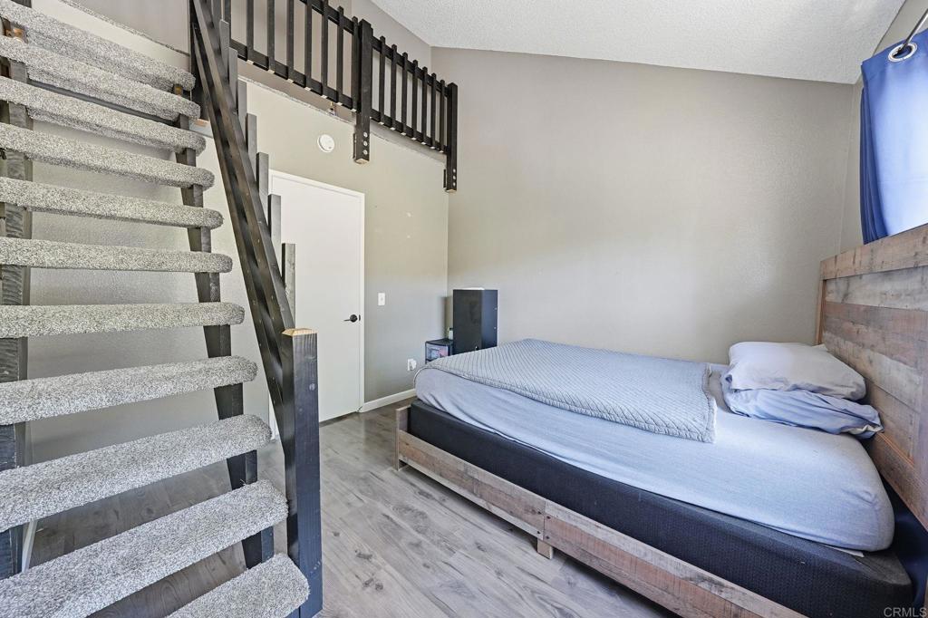 8765 Spring Canyon Drive Spring Valley, CA 91977 - Photo 30 of 37 a bedroom with a bed and a wooden floor