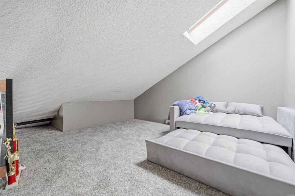 8765 Spring Canyon Drive Spring Valley, CA 91977 - Photo 31 of 37 a bedroom with a bed and a table