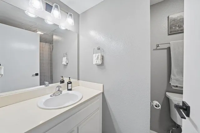 a bathroom with a shower and a toilet next to a window