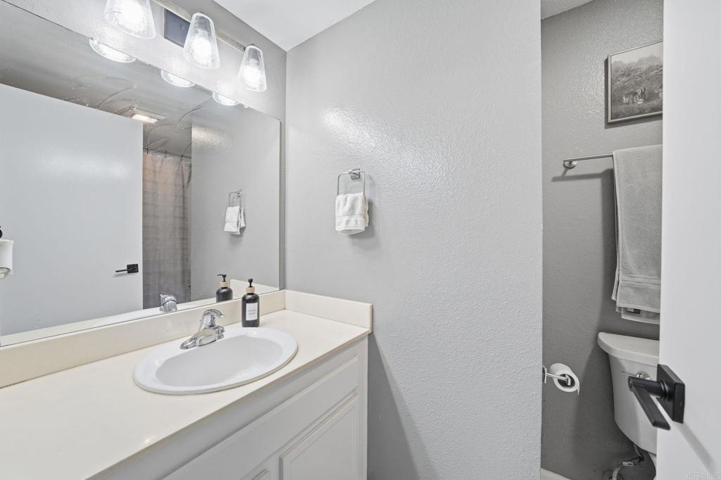 8765 Spring Canyon Drive Spring Valley, CA 91977 - Photo 33 of 37 a bathroom with a sink double vanity and a mirror