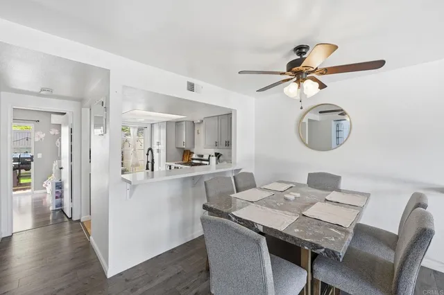 a view of a dining room with furniture wooden floor and a chandelier
