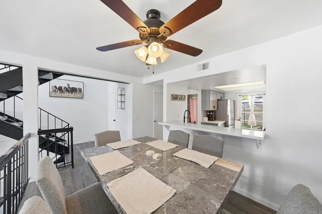 a kitchen with a sink dishwasher a stove and a potted plant