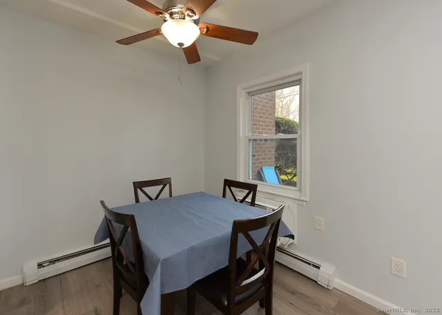 a view of a dining room with furniture and window