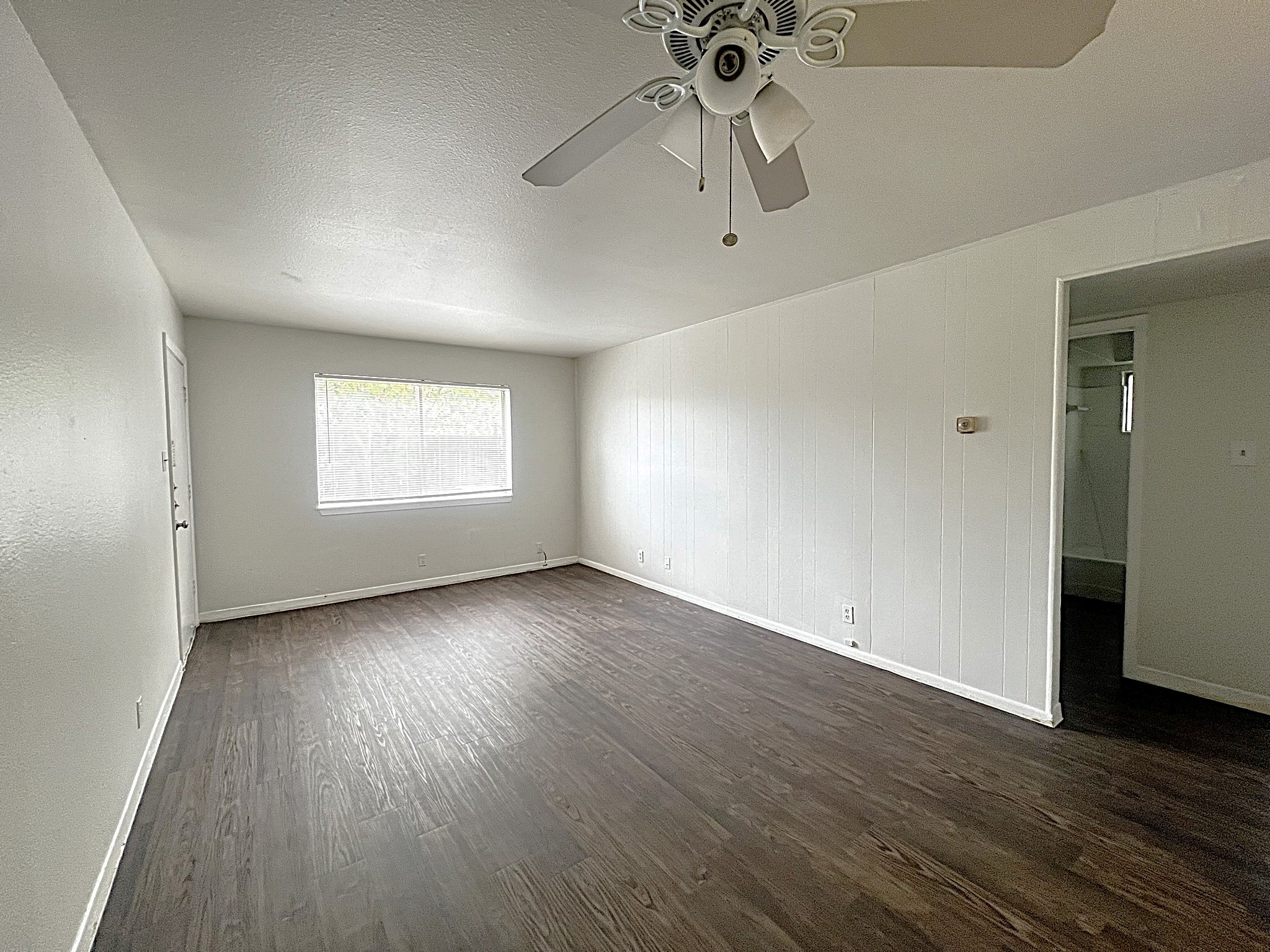 1037 East 44th Street, Unit 101 Austin, TX 78751 - Photo 5 of 9 an empty room with wooden floor and windows