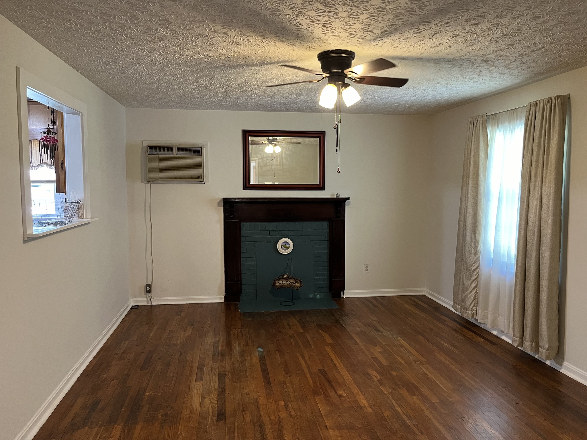 1716 New Hope Road Joelton, TN 37080 - Photo 3 of 23 a view of an empty room with wooden floor and a window