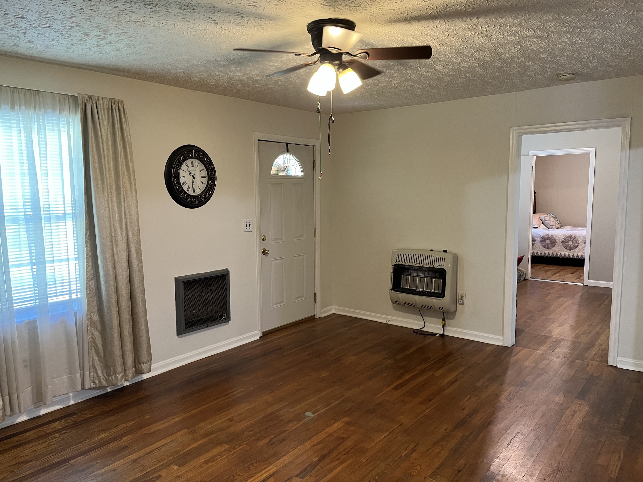 1716 New Hope Road Joelton, TN 37080 - Photo 4 of 23 a view of an empty room with wooden floor and a window