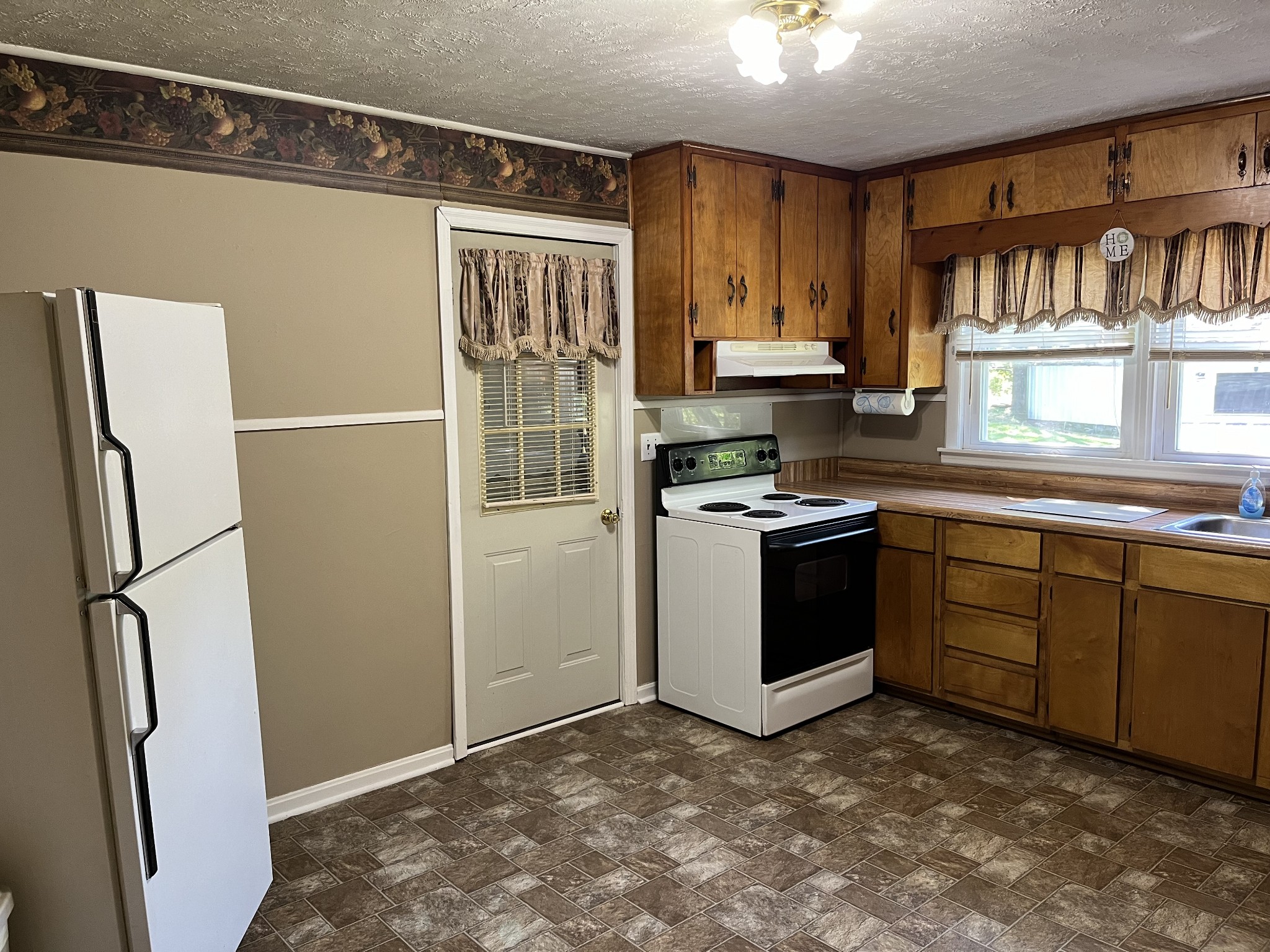 1716 New Hope Road Joelton, TN 37080 - Photo 5 of 23 a kitchen with stainless steel appliances a refrigerator sink and cabinets