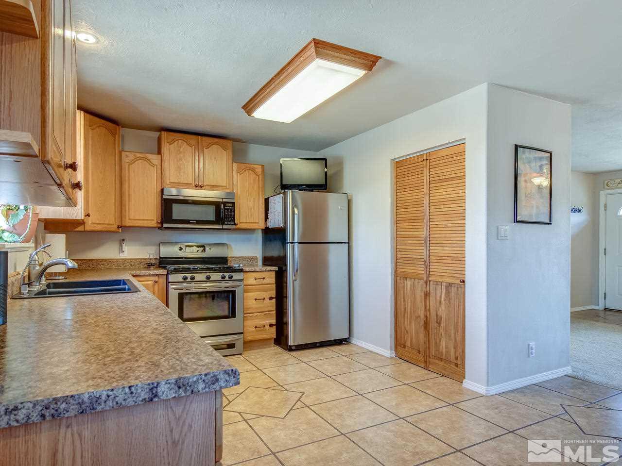 805 Hidden Canyon Road Reno, NV 89510 - Photo 5 of 24 a kitchen with stainless steel appliances granite countertop a refrigerator stove and sink