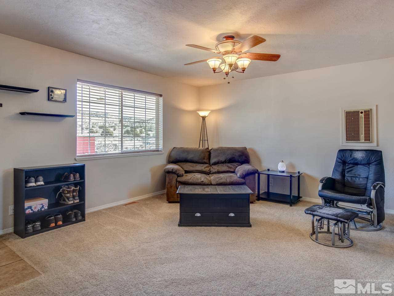 805 Hidden Canyon Road Reno, NV 89510 - Photo 7 of 24 a living room with furniture and a chandelier