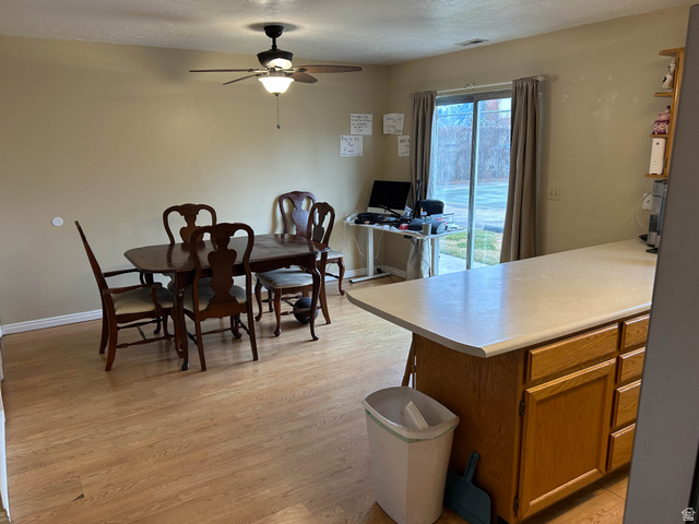939 South Freedom Boulevard, Unit 13 Provo, UT 84601 - Photo 7 of 26 Dining space featuring light wood finished floors, a ceiling fan, and a textured ceiling