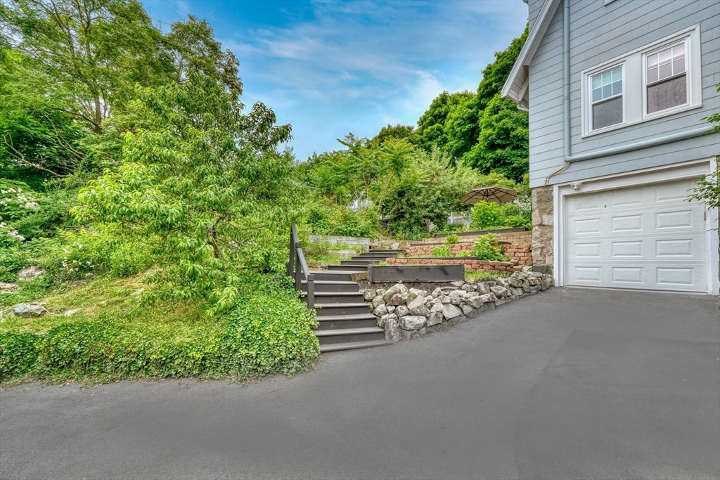 14 Paul Road Medford, MA 02155 - Photo 32 of 42 a wooden bench sitting in front of a building