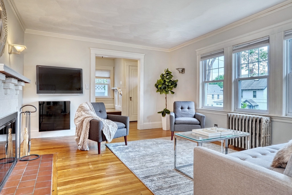 14 Paul Road Medford, MA 02155 - Photo 6 of 42 a living room with fireplace furniture and a flat screen tv