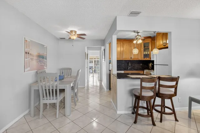 a kitchen with a refrigerator sink and cabinets