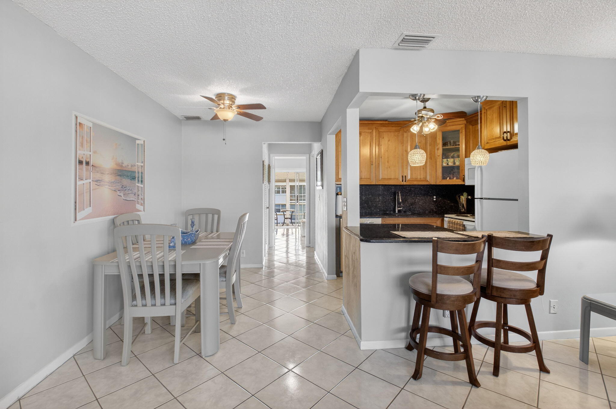 770 Horizon Street East, Unit 311 Boynton Beach, FL 33435 - Photo 18 of 52 a view of a dining room with furniture and chandelier