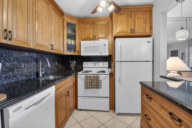 a kitchen with a appliances a sink and cabinets