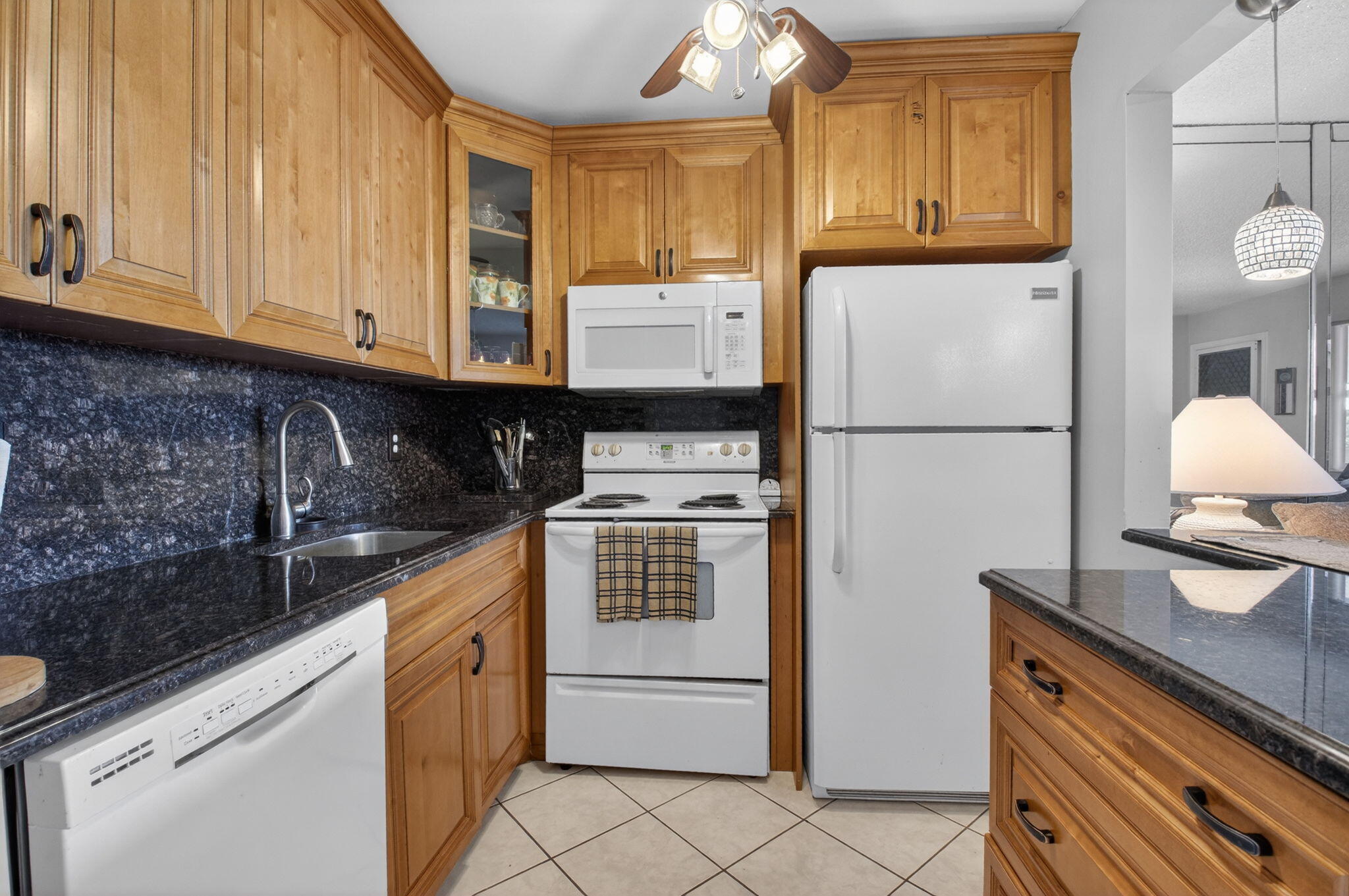 770 Horizon Street East, Unit 311 Boynton Beach, FL 33435 - Photo 19 of 52 a kitchen with a refrigerator sink and cabinets