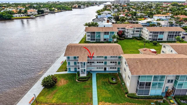 a aerial view of a house with a garden and lake view