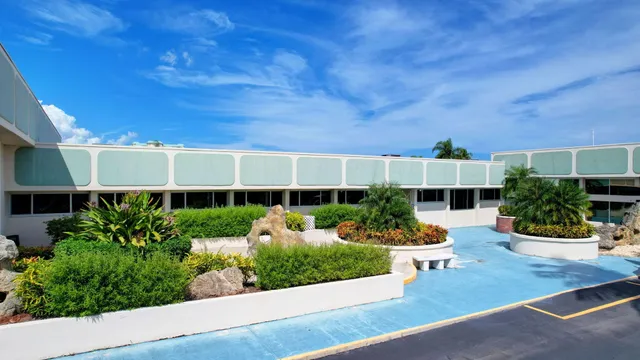 a view of a swimming pool with outdoor seating