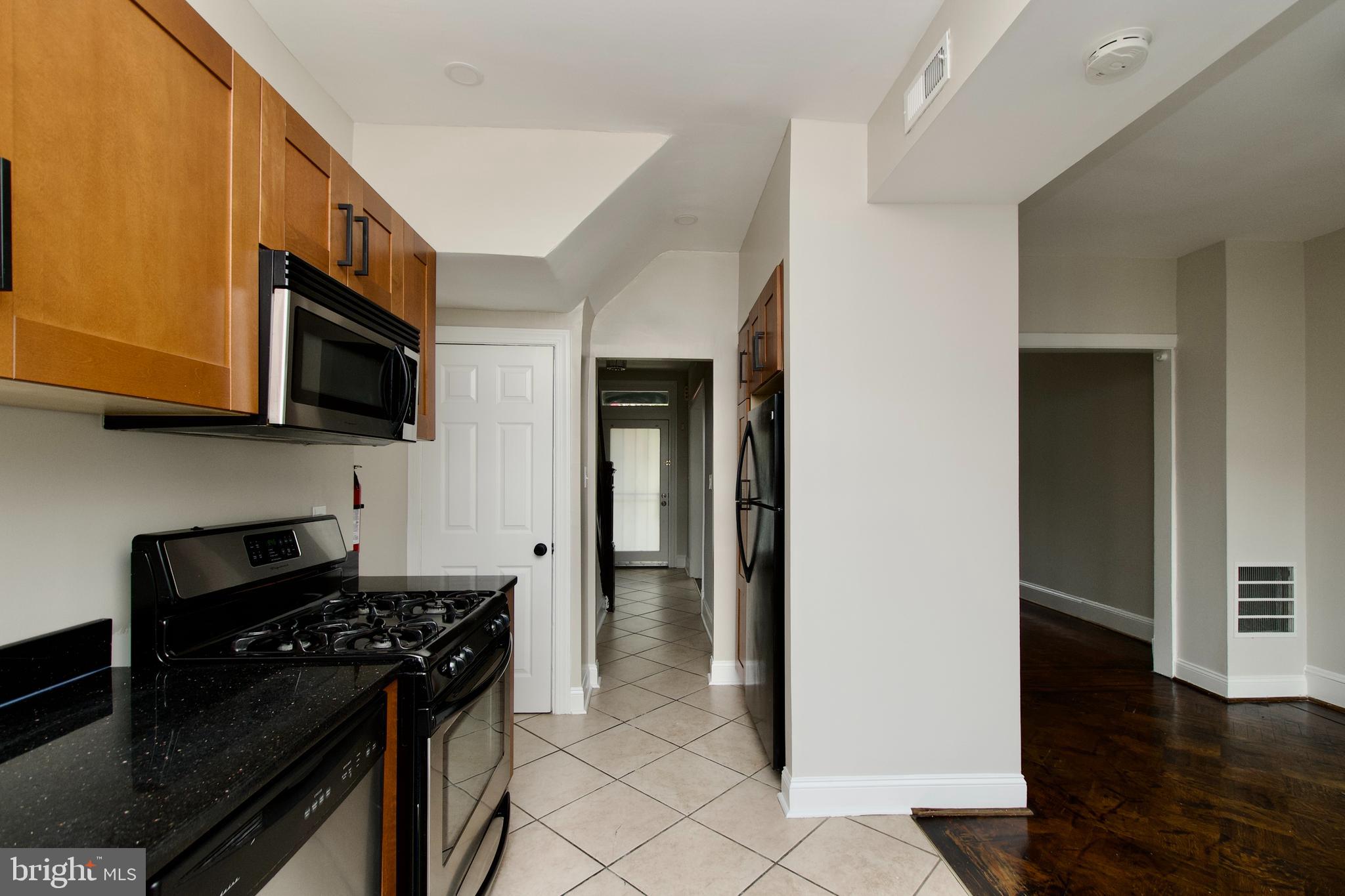 116 Todd Place Northeast Washington, DC 20002 - Photo 12 of 34 a kitchen with stainless steel appliances granite countertop a stove and a microwave