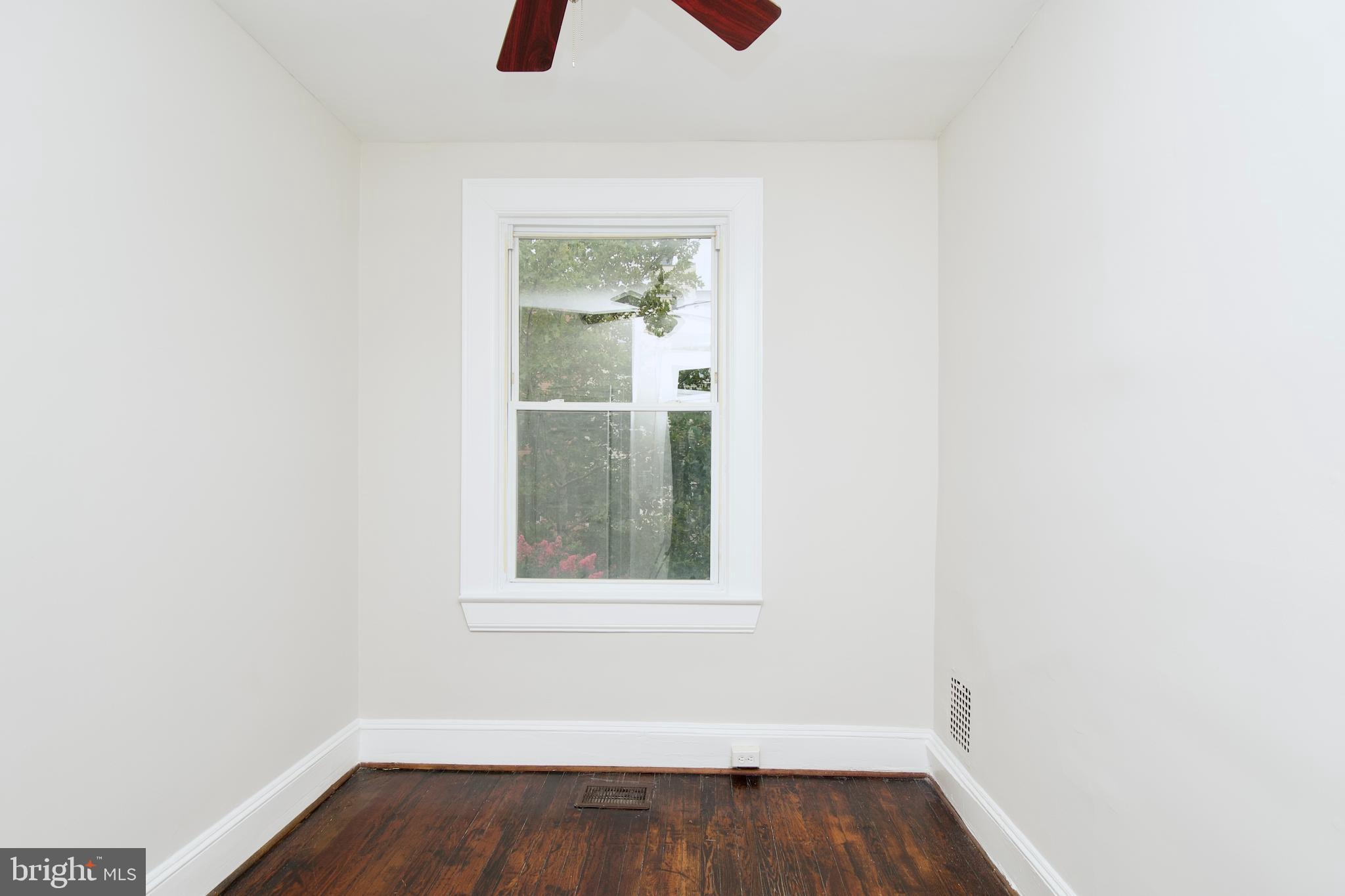 116 Todd Place Northeast Washington, DC 20002 - Photo 16 of 34 a view of an empty room with wooden floor and a window