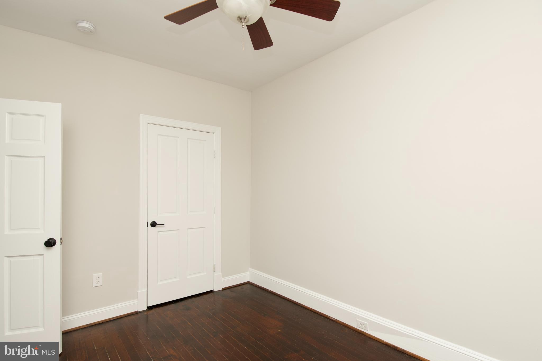 116 Todd Place Northeast Washington, DC 20002 - Photo 21 of 34 an empty room with wooden floor and ceiling fan