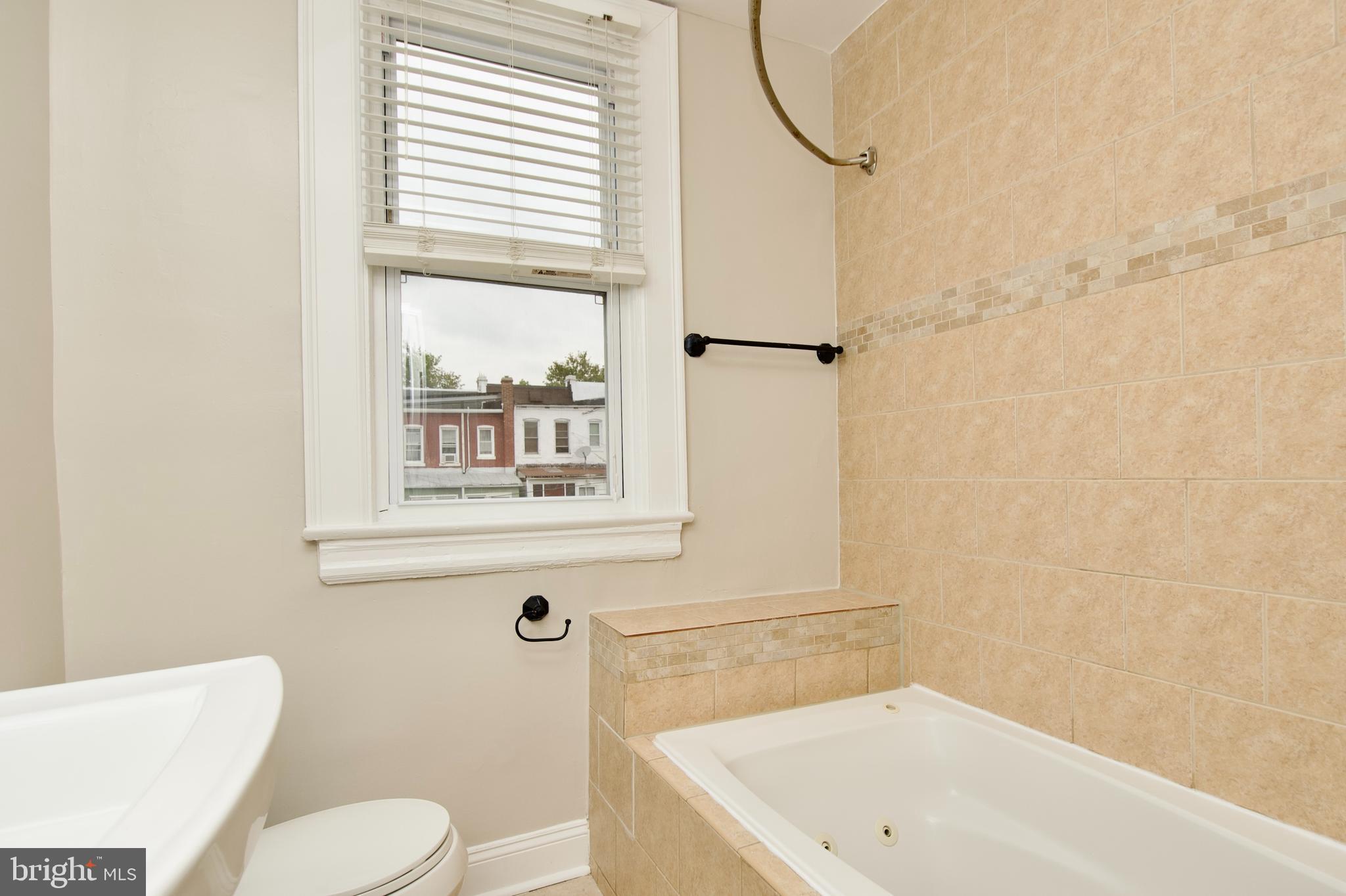 116 Todd Place Northeast Washington, DC 20002 - Photo 22 of 34 a bathroom with a sink toilet and shower