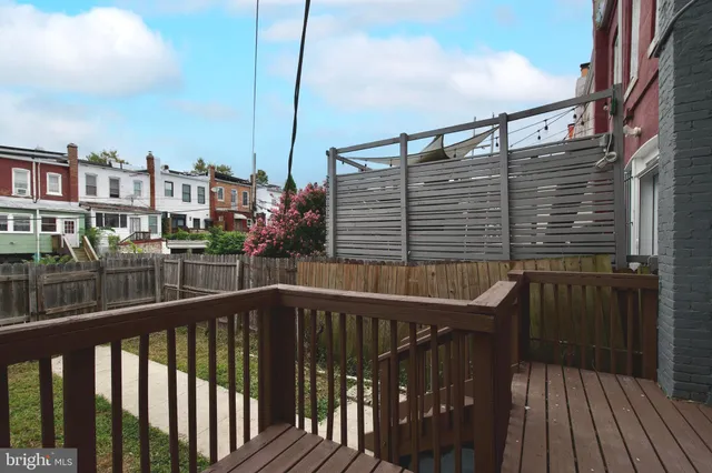 a view of a house with iron fence