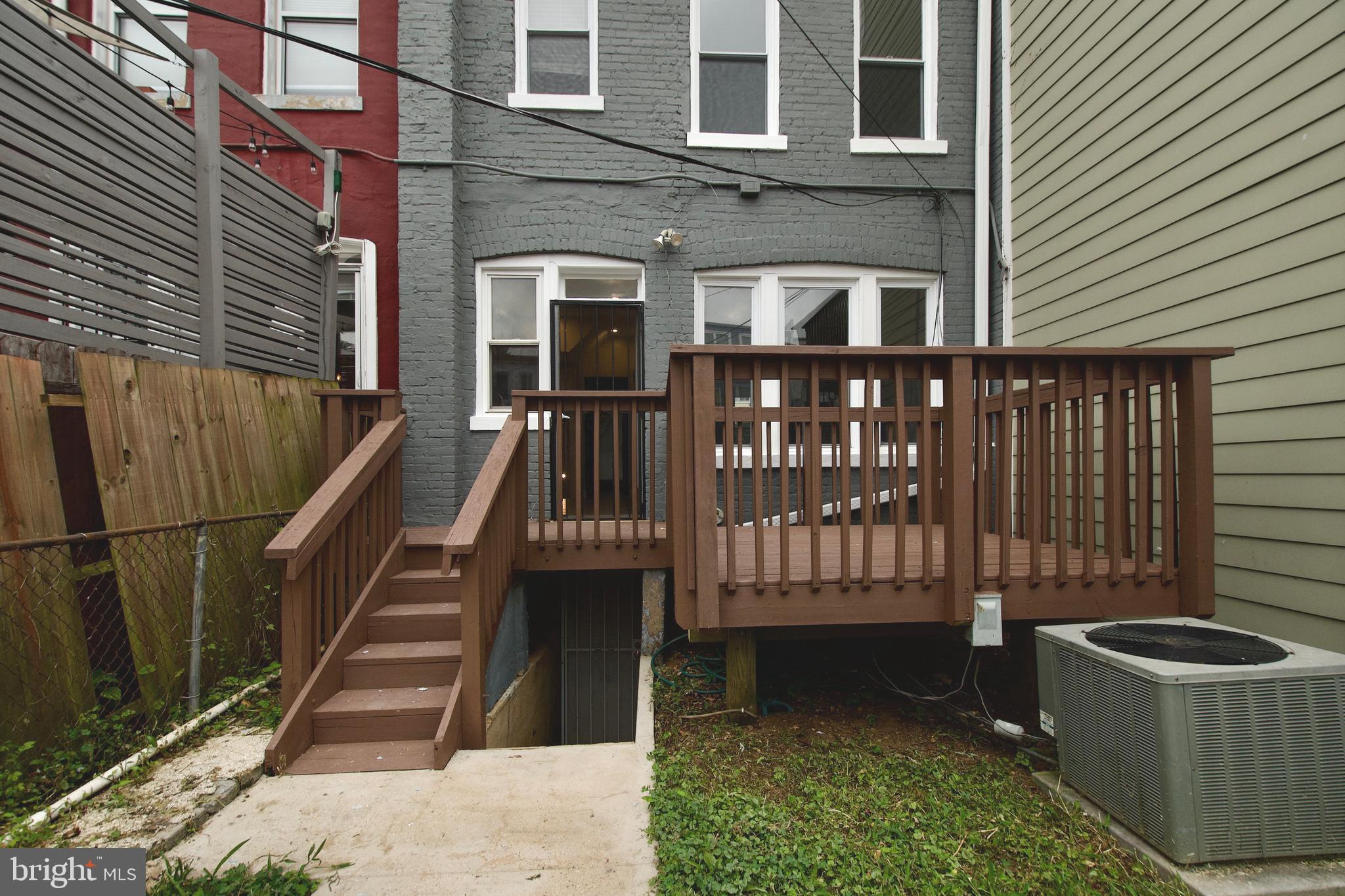116 Todd Place Northeast Washington, DC 20002 - Photo 32 of 34 a view of a brick house with large windows and wooden fence