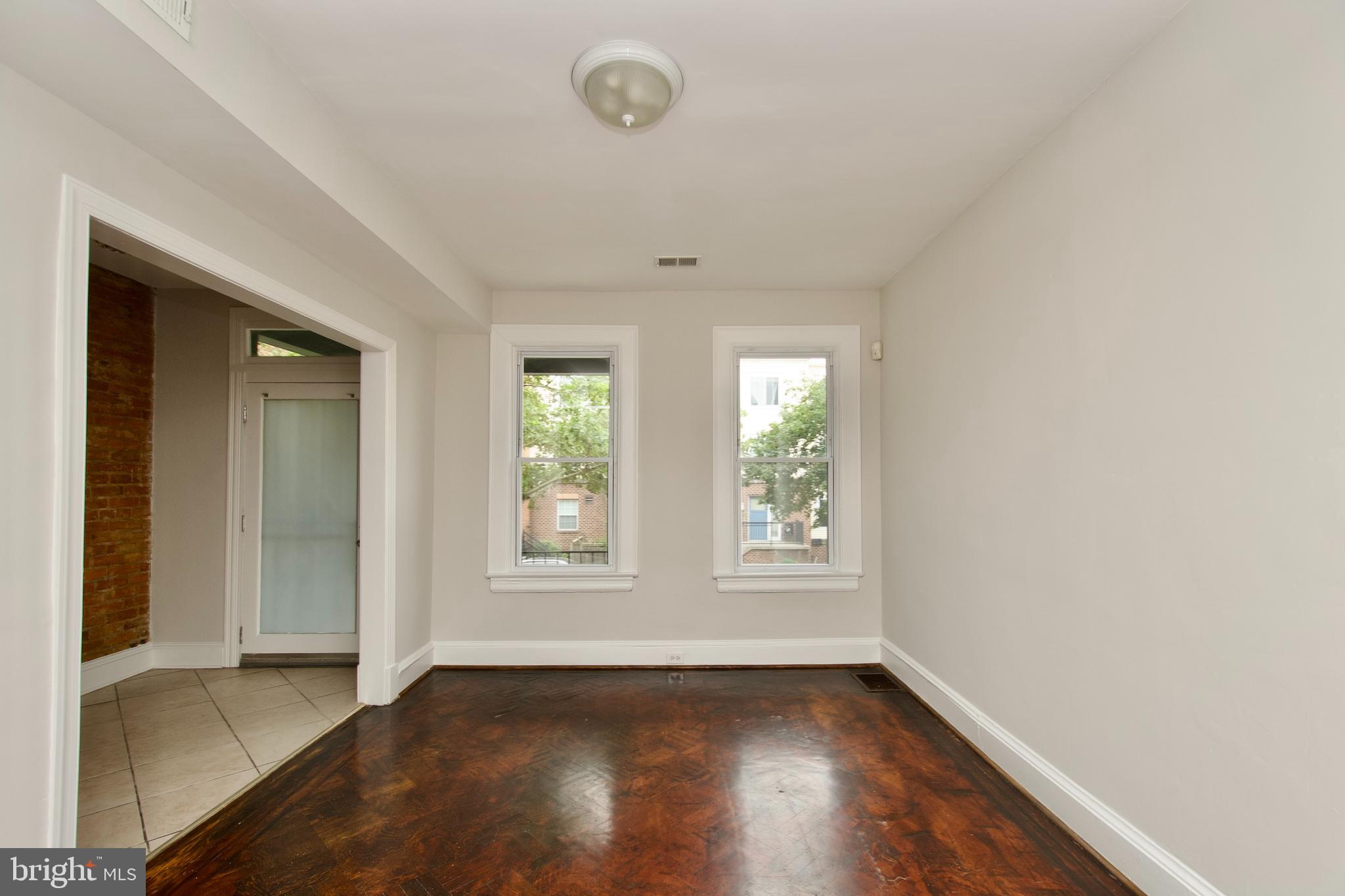116 Todd Place Northeast Washington, DC 20002 - Photo 6 of 34 an empty room with wooden floor and windows
