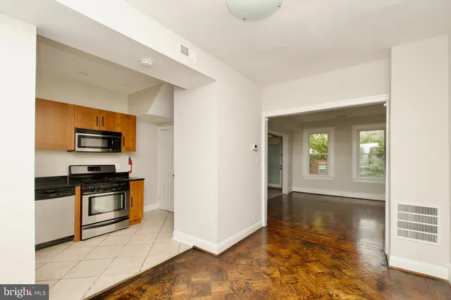a kitchen with stainless steel appliances granite countertop a stove and a microwave