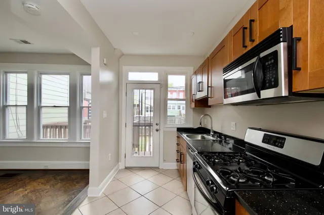 a kitchen with stainless steel appliances granite countertop a stove and a microwave
