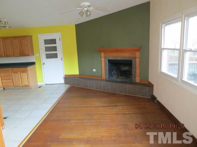 4107 North New Hope Road Raleigh, NC 27604 - Photo 8 of 10 a view of an empty room with a fireplace and a window