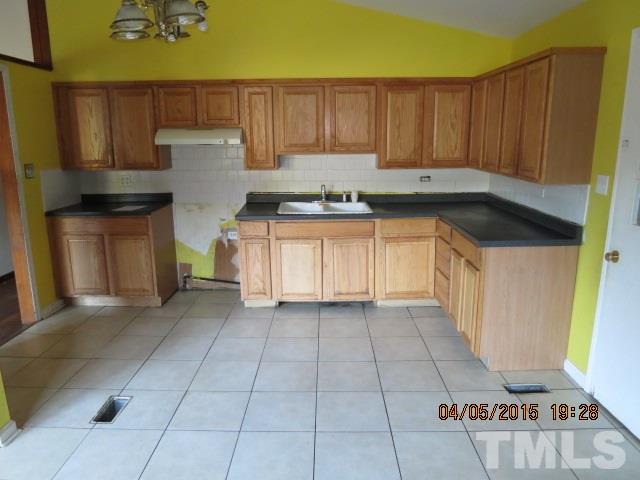 4107 North New Hope Road Raleigh, NC 27604 - Photo 10 of 10 a kitchen with granite countertop a stove a sink and a refrigerator