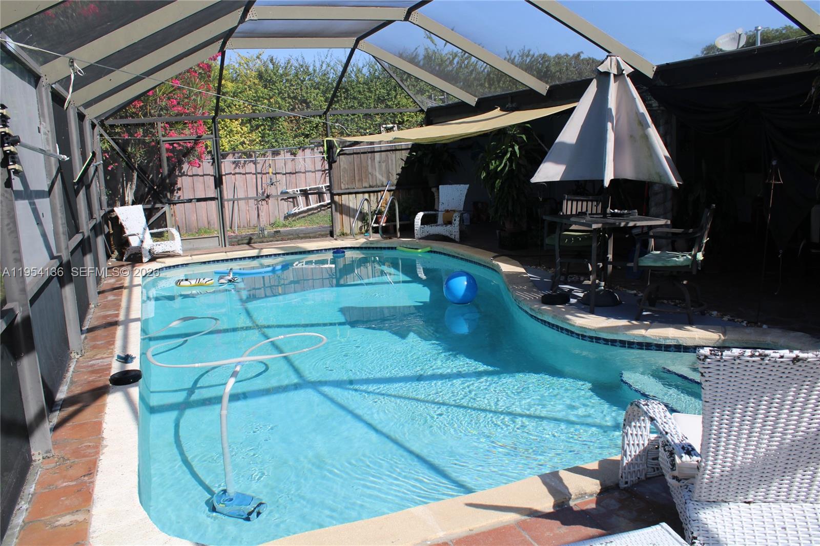 6030 Southwest 93rd Court Miami, FL 33173 - Photo 4 of 9 a view of a swimming pool with a patio