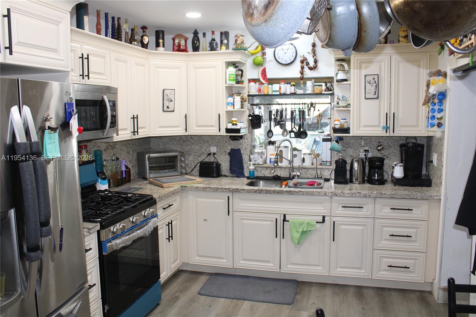 6030 Southwest 93rd Court Miami, FL 33173 - Photo 5 of 9 a kitchen with stainless steel appliances granite countertop a sink and cabinets