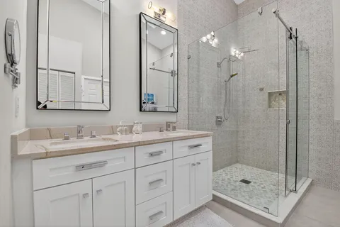 a bathroom with a shower sink and mirror