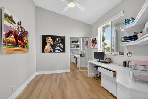 a view of a livingroom with workspace and a window