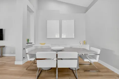 a view of a dining room with furniture and wooden floor