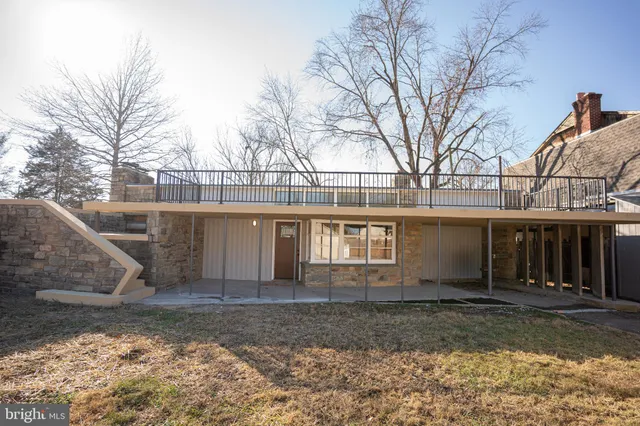 a view of a house with a yard covered in snow