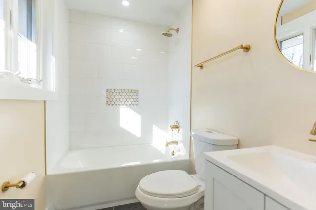 a white toilet sitting next to a bathroom sink