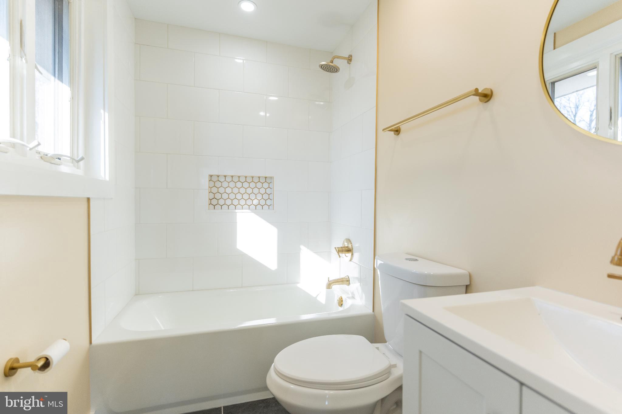 102 East Washington Street, Unit B Remington, VA 22734 - Photo 12 of 21 a white toilet sitting next to a bathroom sink