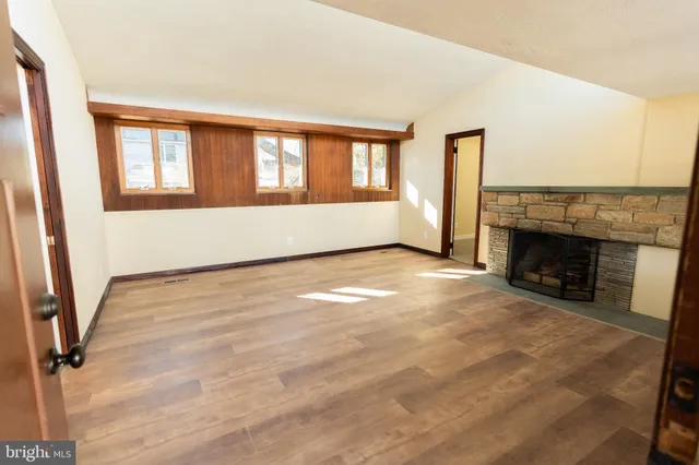 a view of an empty room with a fireplace