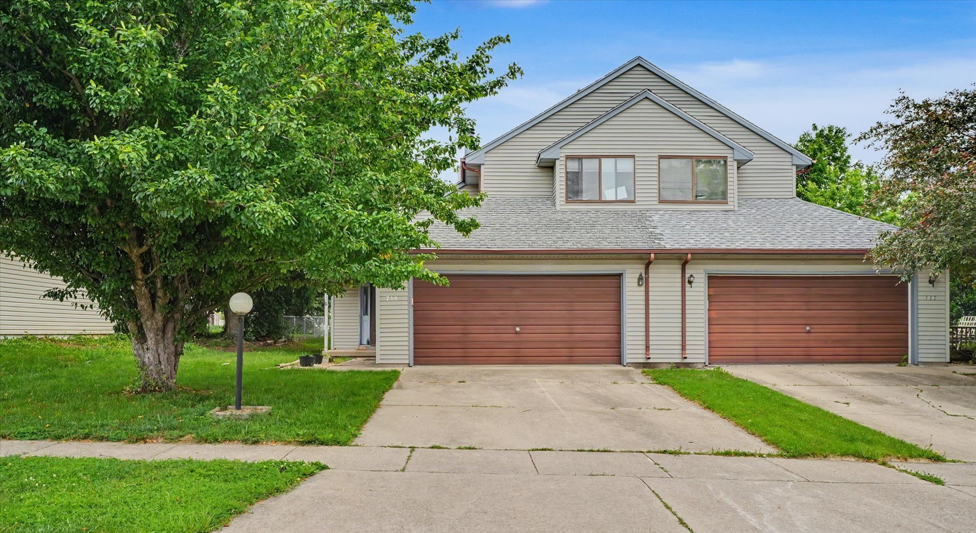 711 Higgins Road Champaign, IL 61822 - Photo 2 of 23 a front view of a house with a yard and a garage