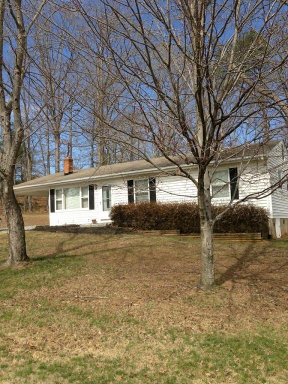 2746 Morgans Mill Road Goodview, VA 24095 - Photo 2 of 13 a front view of a house with a yard