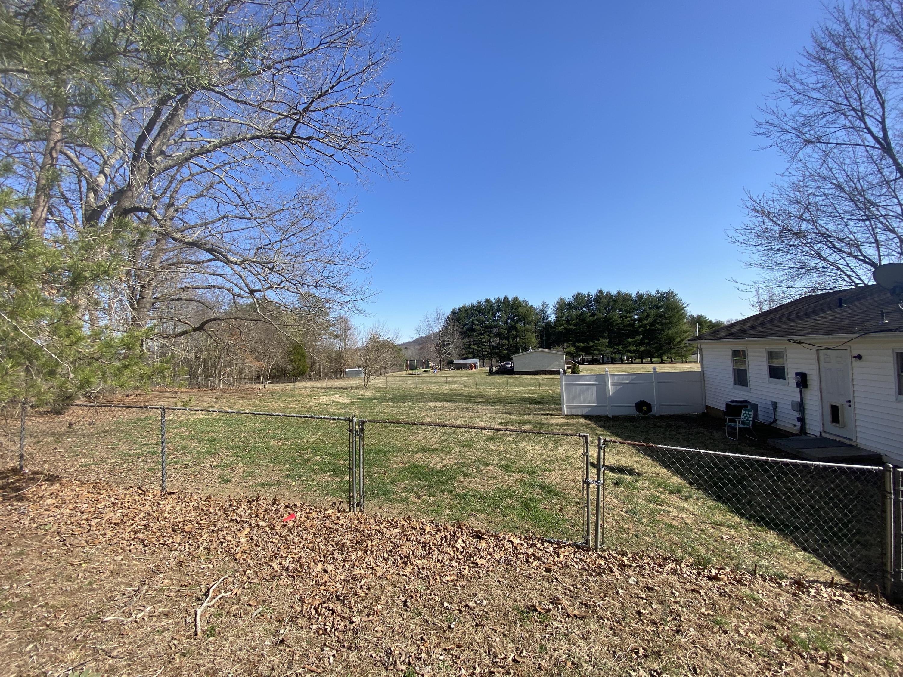 2746 Morgans Mill Road Goodview, VA 24095 - Photo 11 of 13 a view of a lake with a house in the background
