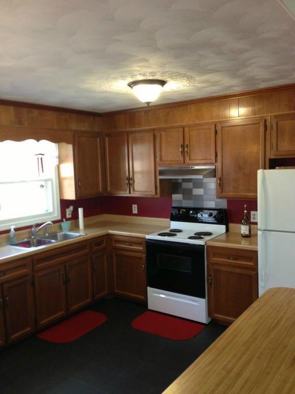 2746 Morgans Mill Road Goodview, VA 24095 - Photo 5 of 13 a kitchen with stainless steel appliances granite countertop a sink and a stove