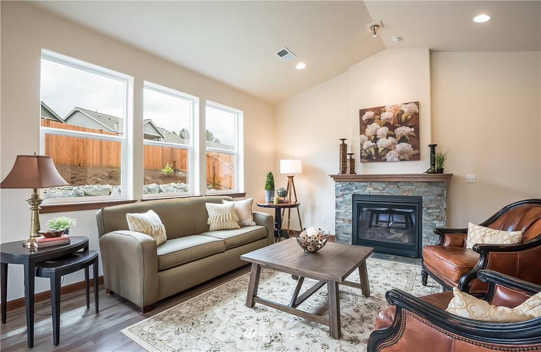5463 Shields Road Ferndale, WA 98248 - Photo 14 of 17 a living room with furniture a fireplace and next to a window