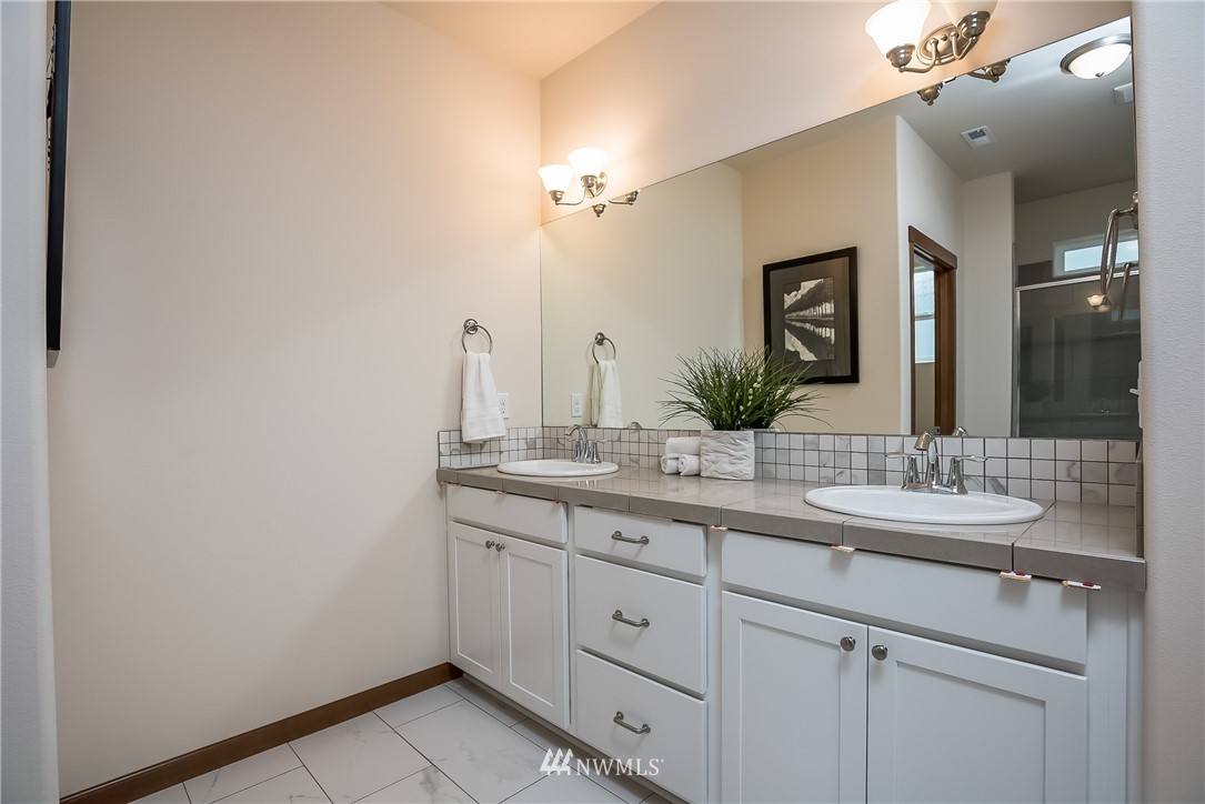 5463 Shields Road Ferndale, WA 98248 - Photo 17 of 17 a bathroom with a granite countertop sink and a mirror