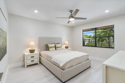 a bedroom with a bed a rug and a window